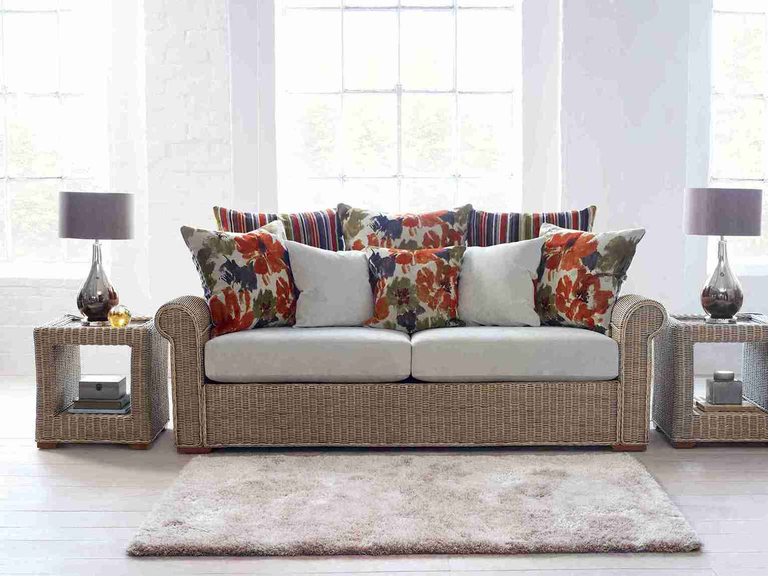 cane conservatory sofa with two side lamps in front of window Bath