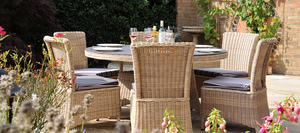 Cane round table and dining chairs in an open space Cirencester