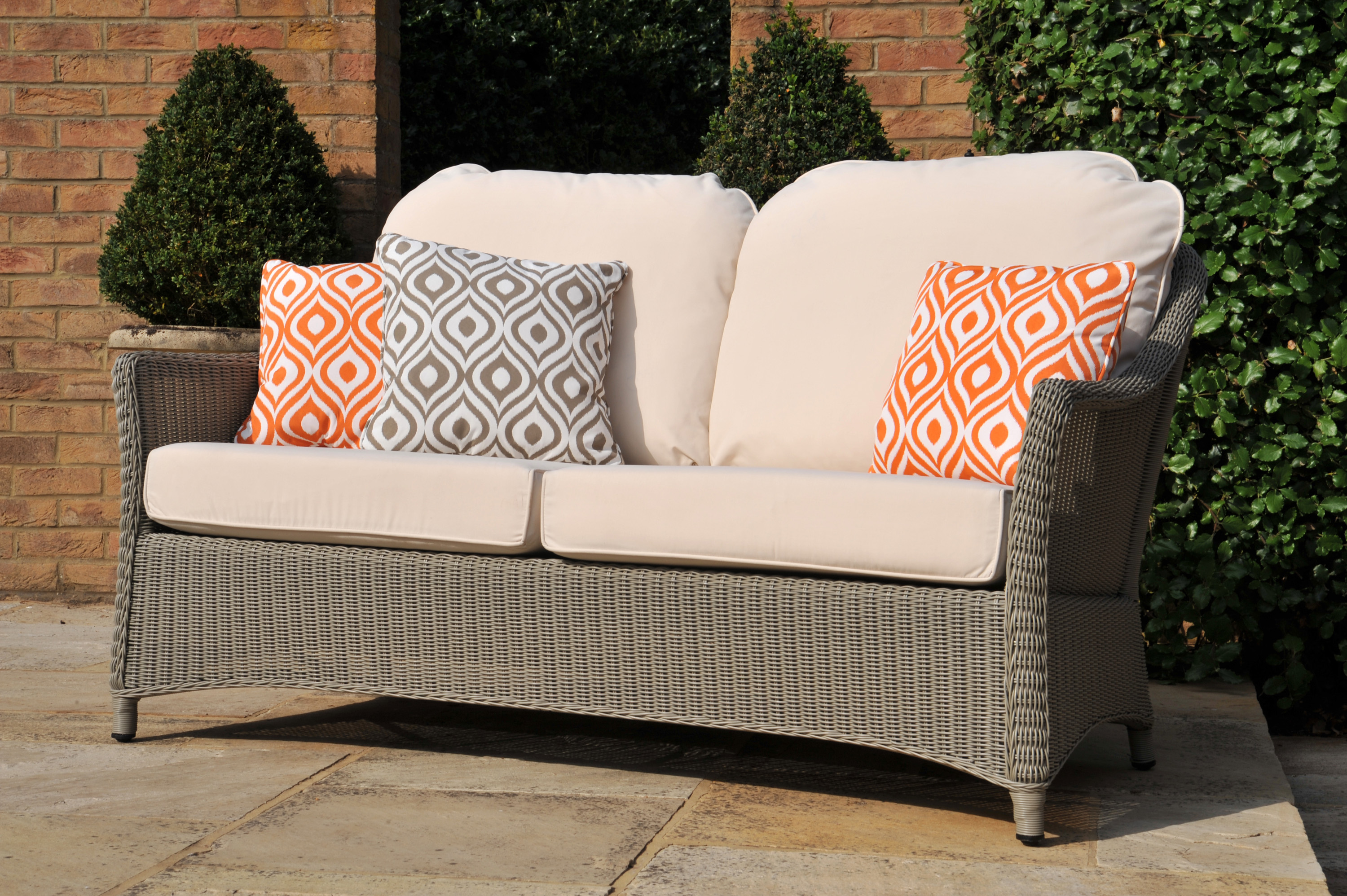 Outdoor cane furniture with red brick building Swindon