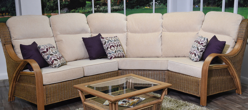 Cane sofa and table in front of window Cirencester