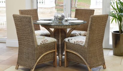 cane dining set in a conservatory