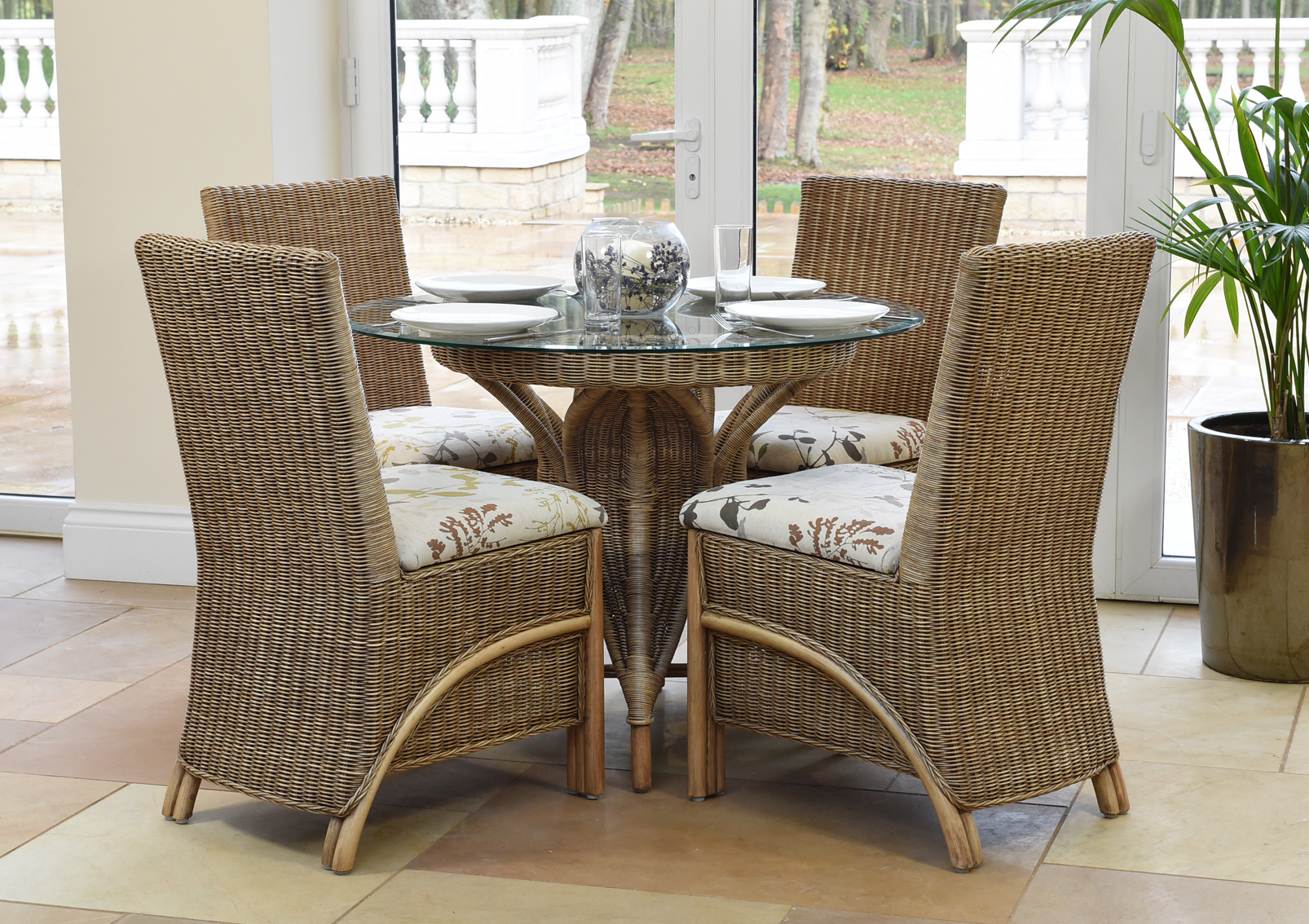 cane dining set in a conservatory