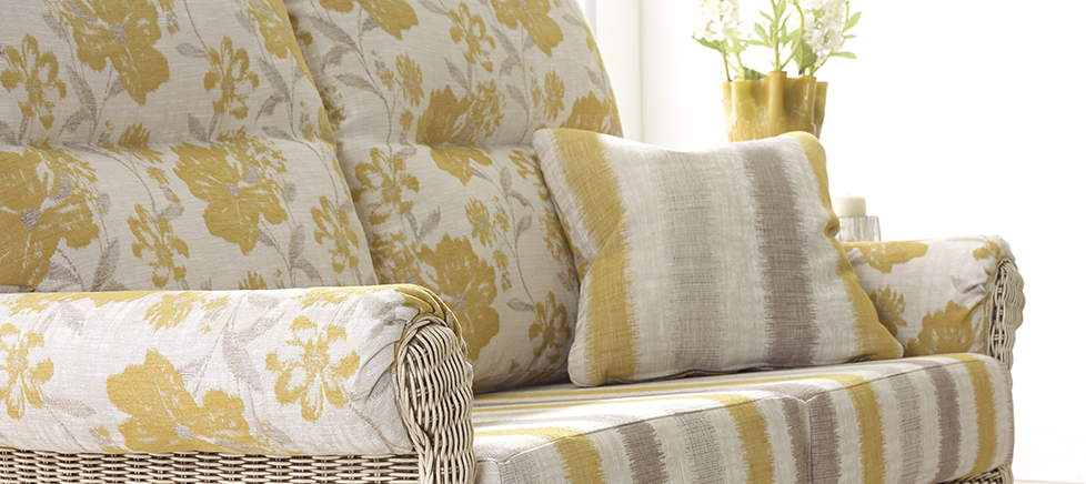 natural cane sofa with floral cushions