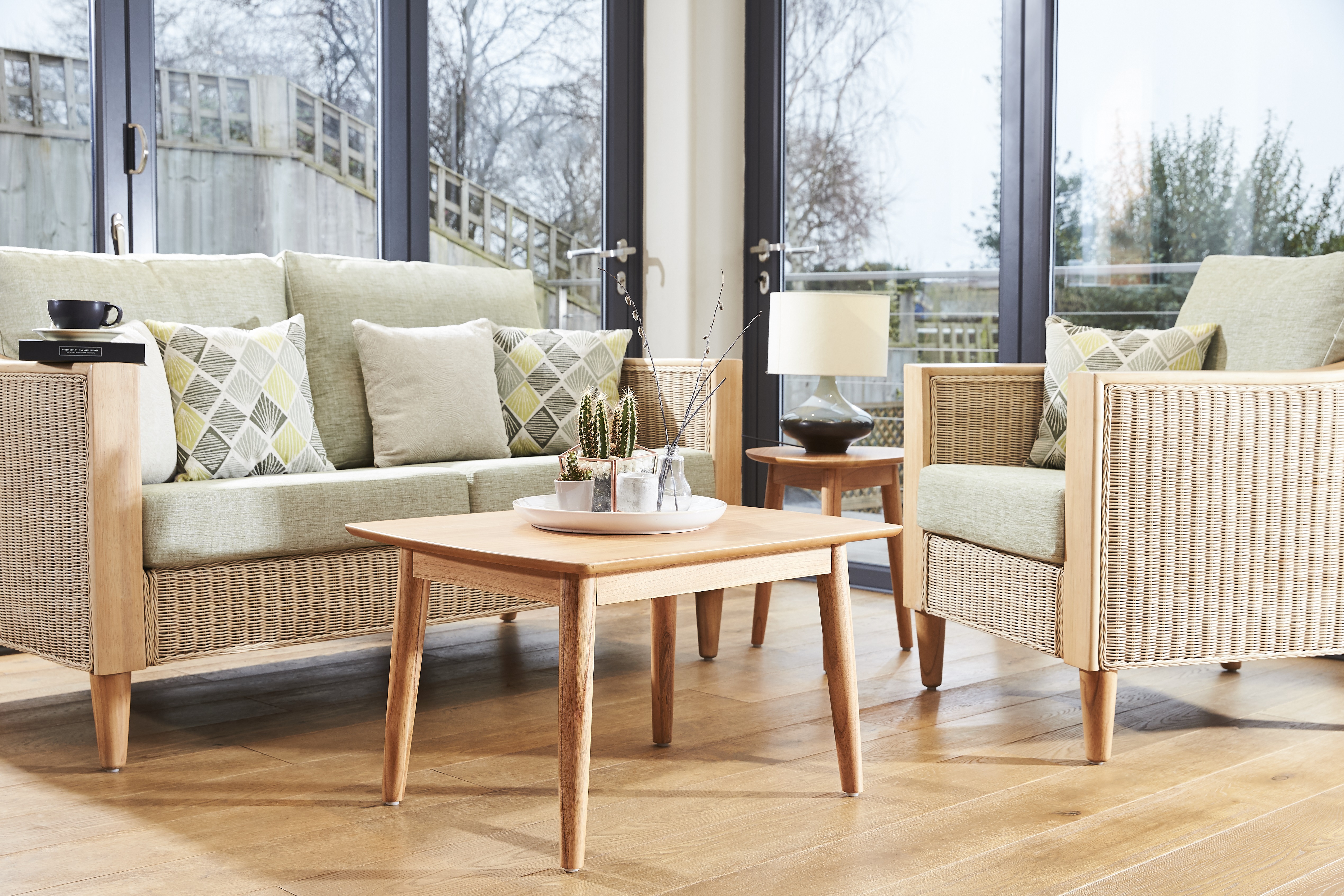 wicker cane furniture suite of table and chair in a conservatory