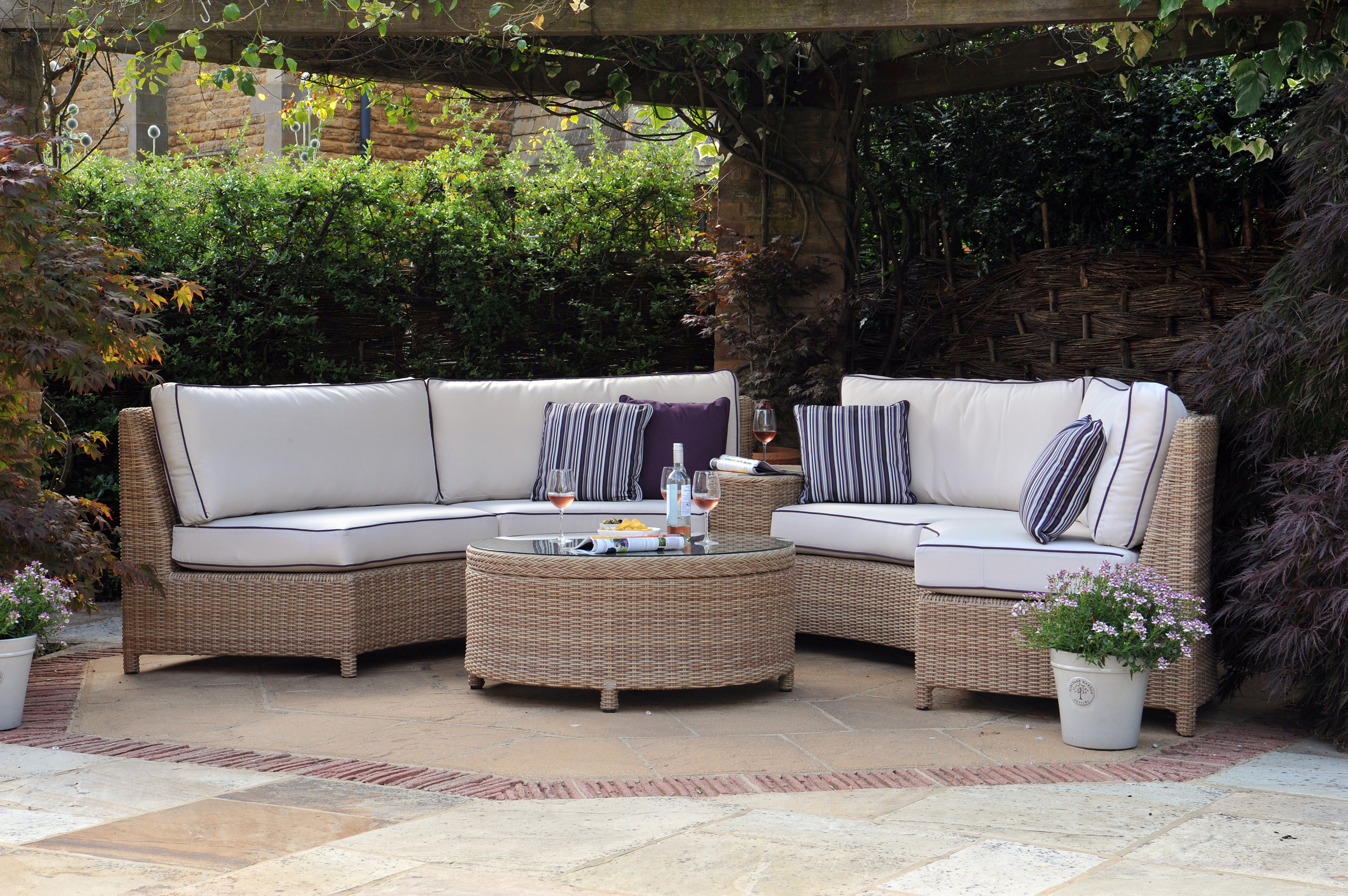 natural rounded cane furniture suite situated on a patio