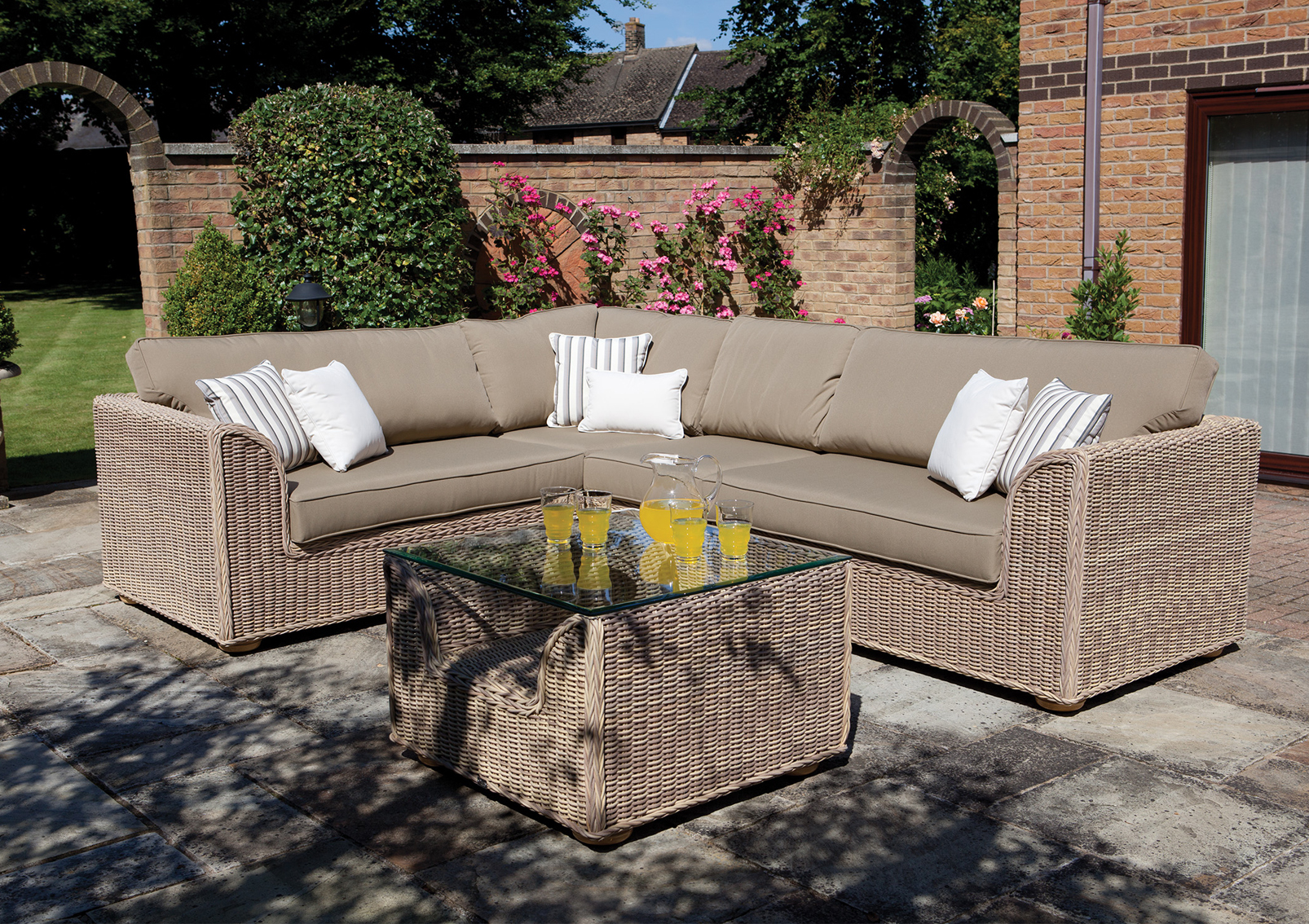 natural cane furniture corner suite set outdoors with cushions