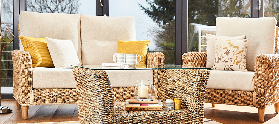 cane furniture table and chair set in a conservatory