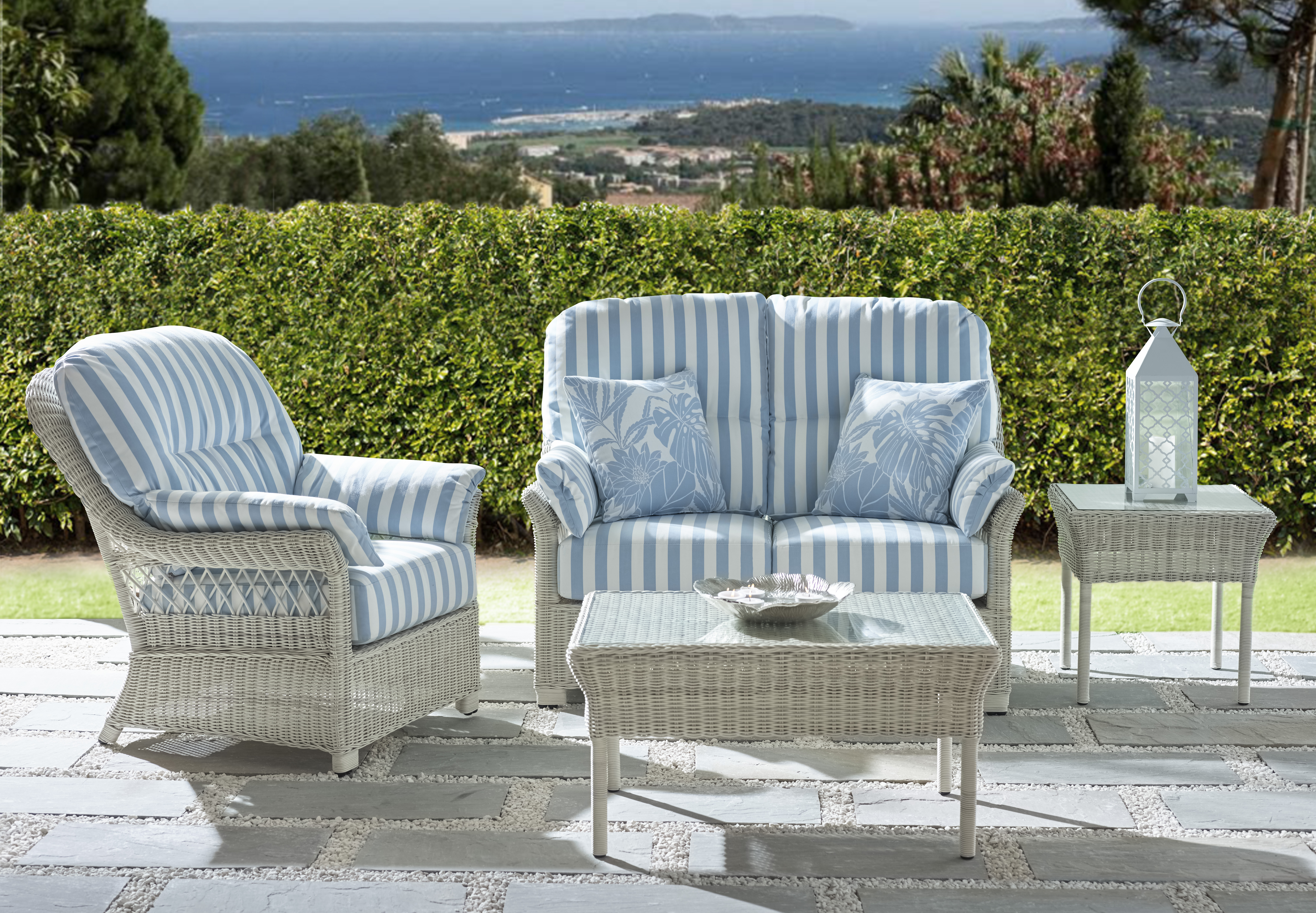 outdoor cane furniture suite with blue striped cushions